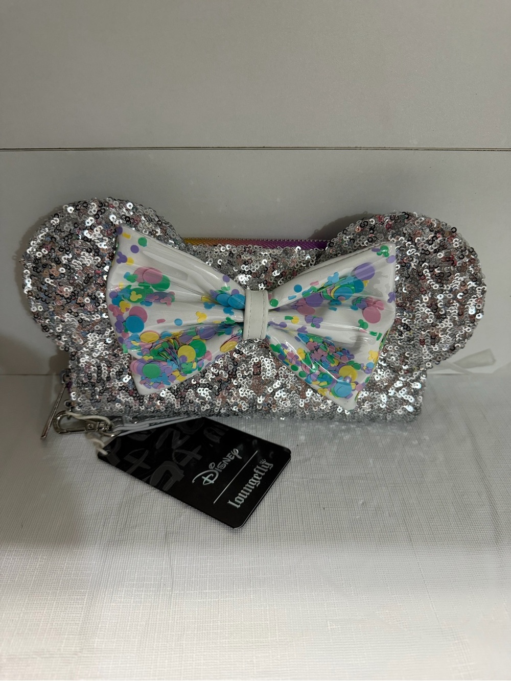 Loungefly Disney Silver Sequin Minnie Ear Wristlet with Colorful Confetti Bow